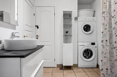 a bathroom with a sink and a washing machine at 941-Thisted-Klitstien-37 in Torsted