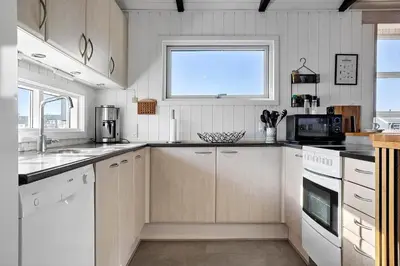 a kitchen with white cabinets and a window at 941-Thisted-Klitstien-37 in Torsted