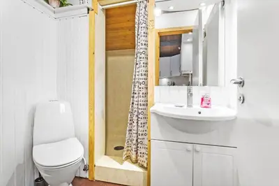 a bathroom with a toilet and a sink and a shower at 851-Thisted-Blabaervej-1 in Thisted