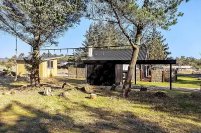 a building in a field with two trees at 1312-Thisted-Kristinesvej-38 in Thisted
