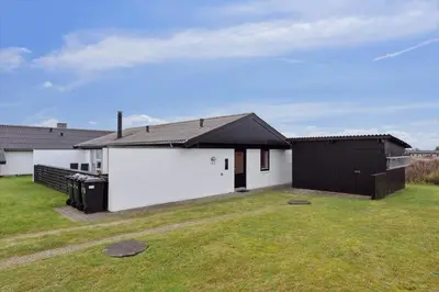 a white house with a black roof and a yard at 699-Thisted-Sotungevej-33 in Thisted