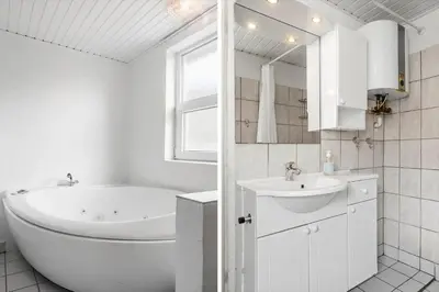 a white bathroom with a tub and a sink at 809-Thisted-Aerenprisvej-11 in Thisted