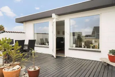 a house with a deck with sliding glass doors at 426-Thisted-Havbovej-26 in Thisted