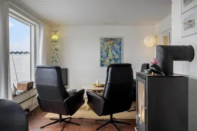 a living room with two chairs and a tv at 426-Thisted-Havbovej-26 in Thisted