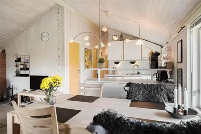 a kitchen and living room with a table and a dining room at 802-Thisted-Pighvarvej-22 in Thisted
