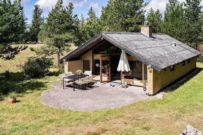 a small house with a table and a patio at 510-Thisted-Egebaksandevej-10 in Thisted