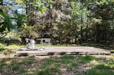 two chairs and a table on a wooden deck at 510-Thisted-Egebaksandevej-10 in Thisted