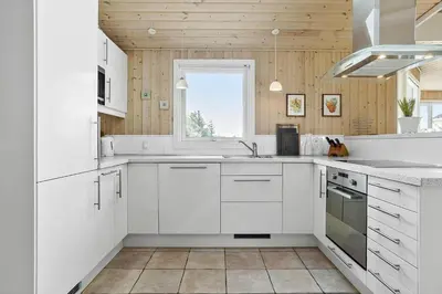 a white kitchen with white cabinets and a window at 658-Thisted-Laksevej-8 in Thisted