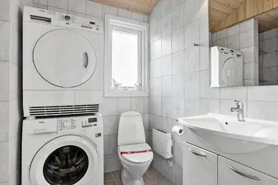 a bathroom with a washing machine and a sink at 658-Thisted-Laksevej-8 in Thisted