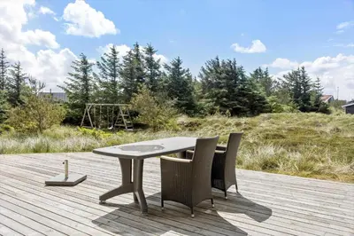 a table and chairs sitting on a wooden deck at 658-Thisted-Laksevej-8 in Thisted