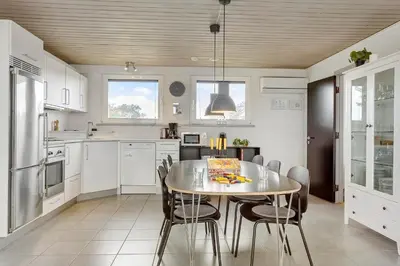 a kitchen with a table and chairs in it at 994-Thisted-Gravsesvej-20 in Torsted