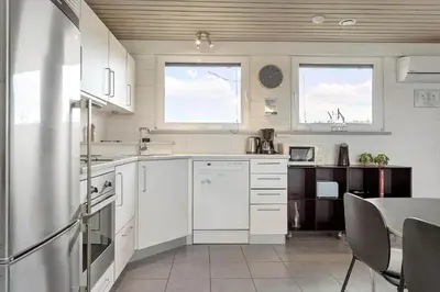 a kitchen with white appliances and a table in it at 994-Thisted-Gravsesvej-20 in Torsted