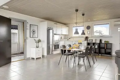 a kitchen with a table and chairs in it at 994-Thisted-Gravsesvej-20 in Torsted