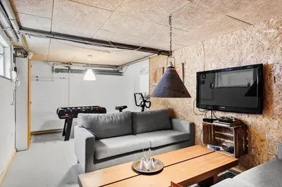 a living room with a couch and a tv at 600-Vestervig-Krik-Strandvej-100 in Vestervig