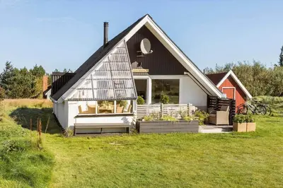 a small house on a field with a green yard at 326-Thisted-Kristinesvej-24 in Thisted