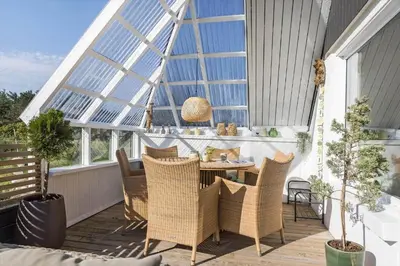 a patio with a table and chairs in a conservatory at 326-Thisted-Kristinesvej-24 in Thisted