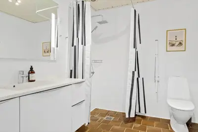 a white bathroom with a shower and a toilet at 650-Thisted-Orredvej-9-A in Thisted