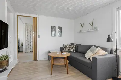 a living room with a gray couch and a table at 790-Thisted-Nordsovej-90 in Thisted