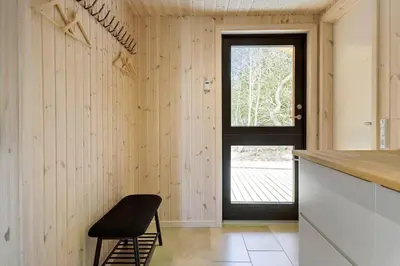 a kitchen with a black door and a stool at 113-Thisted-Muslingevej-13-D in Thisted