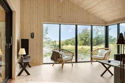 a living room with chairs and a table and windows at 113-Thisted-Muslingevej-13-D in Thisted