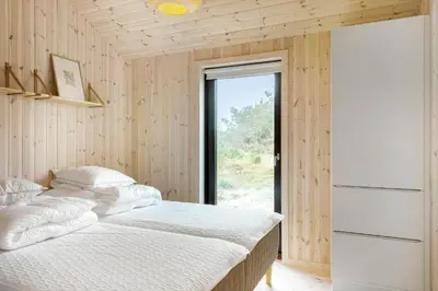 a bedroom with a bed and a large window at 113-Thisted-Muslingevej-13-D in Thisted