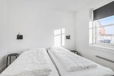 a white room with two beds and a window at 161-Hanstholm-Kraegpotvej-161 in Hanstholm
