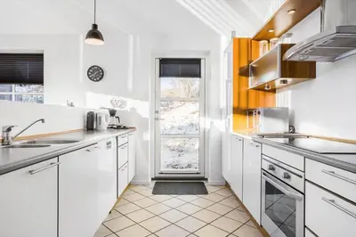 a kitchen with white cabinets and a large window at 161-Hanstholm-Kraegpotvej-161 in Hanstholm