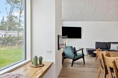 a living room with a tv and a table and chairs at 667-Thisted-Smedevej-3-C in Thisted