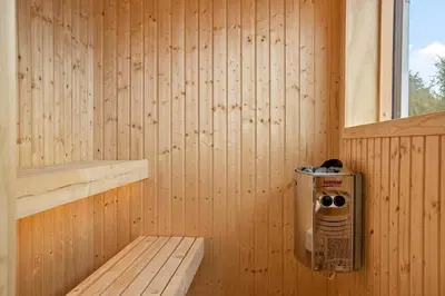 a sauna with a bench in a wooden wall at 667-Thisted-Smedevej-3-C in Thisted