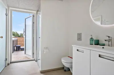 a white bathroom with a toilet and a mirror at 667-Thisted-Smedevej-3-C in Thisted
