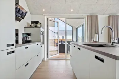 a kitchen with white cabinets and a large sink at 667-Thisted-Smedevej-3-C in Thisted
