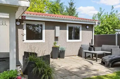 a patio of a house with a table and chairs at 317-Thisted-Molgaardsvej-65 in Thisted