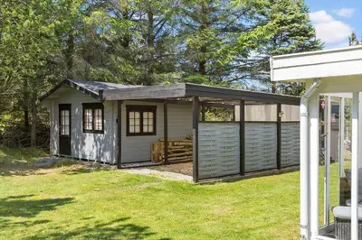 a small shed with a garage door on a yard at 317-Thisted-Molgaardsvej-65 in Thisted