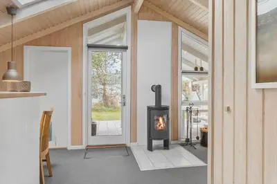 a fireplace in a living room with a stove at 772-Thisted-Hummervej-6 in Thisted