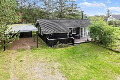 a small black house with a yard at 712-Vestervig-Kanalvej-12 in Vestervig