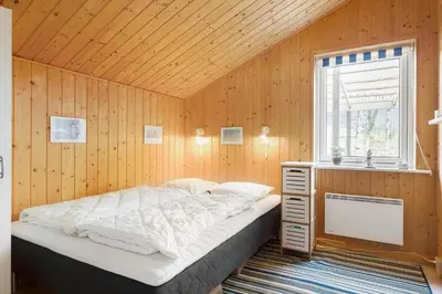 a bedroom with a bed and a desk and a window at 712-Vestervig-Kanalvej-12 in Vestervig