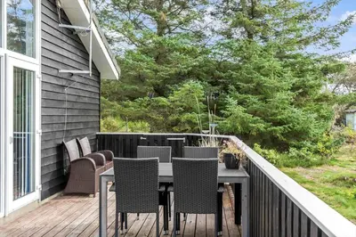 a patio with a table and chairs on a deck at 712-Vestervig-Kanalvej-12 in Vestervig