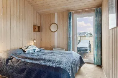 a bedroom with a bed and a window with a balcony at 947-Thisted-Niels-Vognmands-Vej-20 in Torsted
