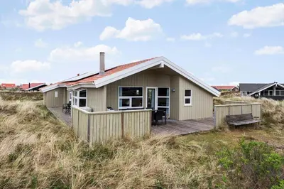a small house on a wooden deck in the sand at 947-Thisted-Niels-Vognmands-Vej-20 in Torsted