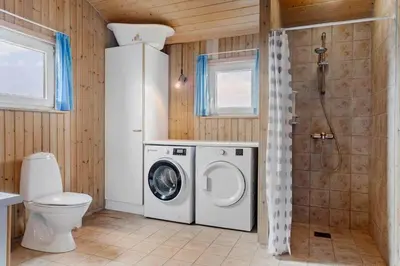 a bathroom with a washing machine and a toilet at 947-Thisted-Niels-Vognmands-Vej-20 in Torsted