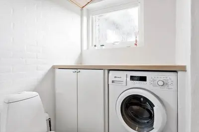 a white laundry room with a washer and dryer at 685-Thisted-Pighvarvej-28 in Thisted