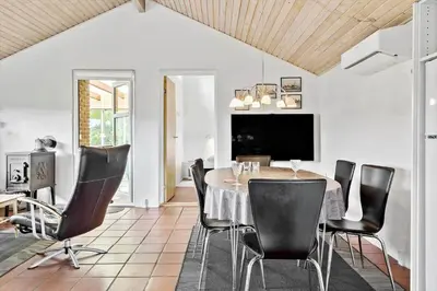 a dining room with a table and black chairs at 685-Thisted-Pighvarvej-28 in Thisted