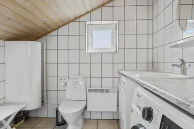 a white bathroom with a toilet and a sink at 867-Thisted-Nordsovej-66 in Thisted