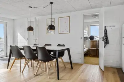 a dining room with a table and black chairs at 867-Thisted-Nordsovej-66 in Thisted