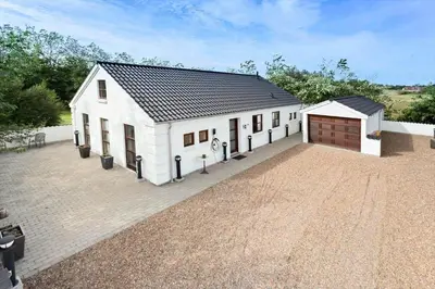 a large white building with a garage at 496-Snedsted-Niels-Juels-Vej-33 in Snedsted