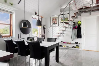 a dining room with a table and chairs and a staircase at 496-Snedsted-Niels-Juels-Vej-33 in Snedsted