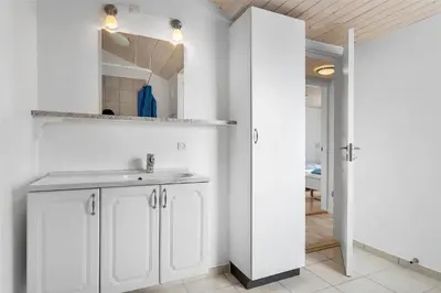 a white bathroom with a sink and a mirror at 618-Thisted-Fiskervej-82 in Thisted