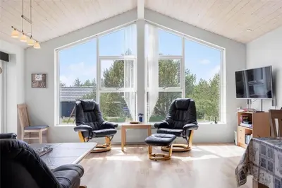 a living room with two chairs and a tv at 618-Thisted-Fiskervej-82 in Thisted
