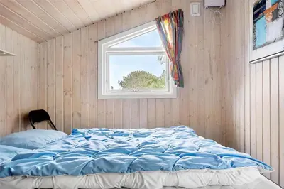 a bed in a room with a window at 618-Thisted-Fiskervej-82 in Thisted