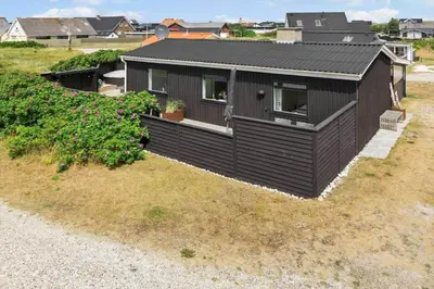 a black house on a hill with a yard at 726-Thisted-Nordsovej-36 in Thisted